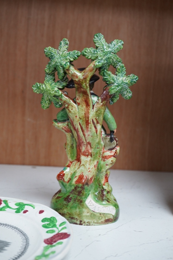 Two early 19th century Walton pearlware figures, the first a man holding a basket flowers, the second a cider costrel, tallest 19.5cm, together with a pearlware nursery plate (3). Condition – some restoration otherwise f